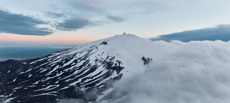 Sn&aelig;fellsj&ouml;kull glacier in clouds at sunset