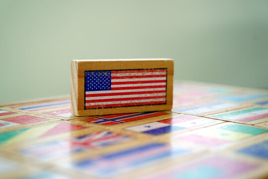 Wooden toy block with American flag on world flags background