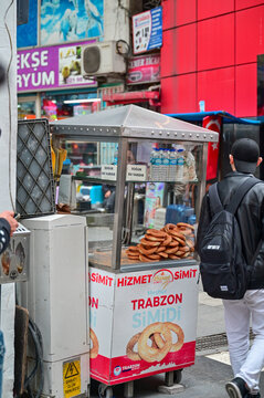 Traditional mobile sales cart for Trabzon simit (sesame rings) in a bustling pedestrian zone in the city center of Trabzon, Black Sea region, T&uuml;rkiye 29.03.2025