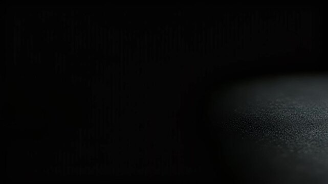 Close-up of fine particles or dust swirling and scattering across a dark, textured