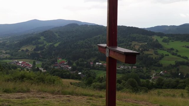 Close Up Camera Orbit Around Wooden Christian Cross Overlooking Valley