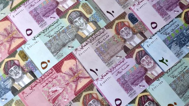 Oman, omani paper money, rial or riyal banknotes and baisa coins as currency for exchange or travel. Omani money as a business background