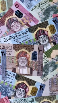 Oman, omani paper money, rial or riyal banknotes and baisa coins as currency for exchange or travel. Omani money as a business background