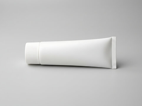Blank white cosmetic tube mockup for cream, gel, or toothpaste packaging isolated on a neutral grey background