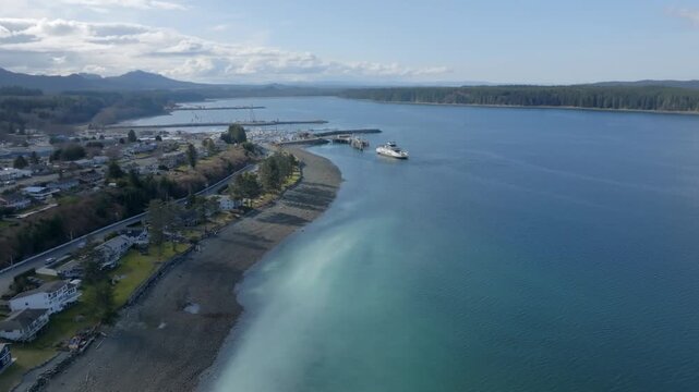 Drone shot of herring spawn happening on the shore of Port McNeill with ferry arriving