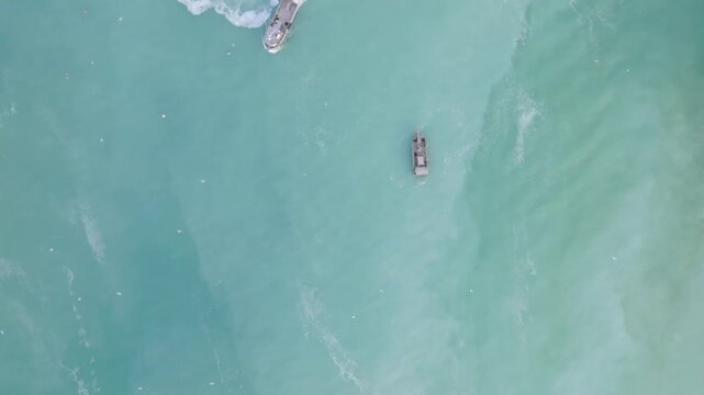 Herring fishing boats fishing for herring during the herring spawn drone shot