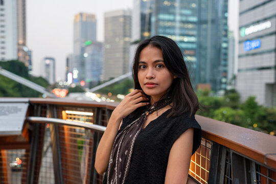 Young indonesian woman posing on pedestrian bridge