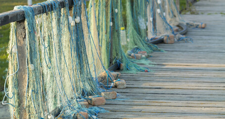 Detail of fishing nets drying on wooden fence of the pontoon © MEDIAIMAG