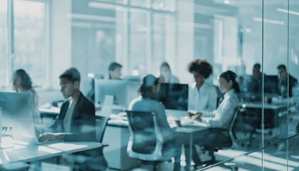 Obraz premium Diverse professional team working in a modern open plan office environment with computers.