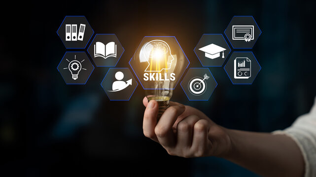 Hand Holding Light Bulb with Icons Representing Education, Skills Development, and Learning Concepts in Abstract Background. Glyphic.