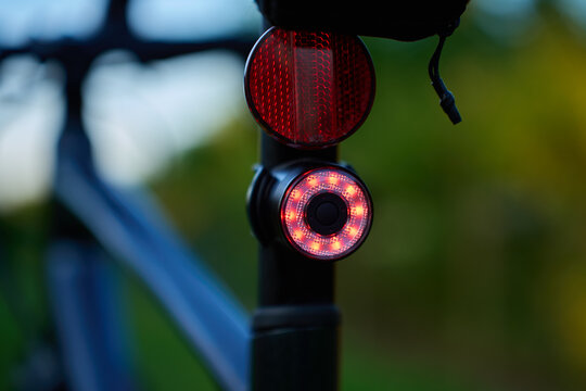 Red rear bike light and reflector on bicycle