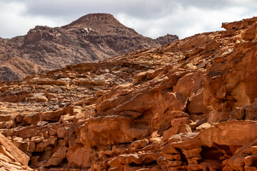 Rugged red sandstone cliffs in desert mountains © Ruslan Bolgov