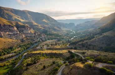 Aerial photography of a gorge with ancient caves and green hills © Игорь Кляхин