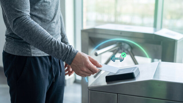 Gym membership access and fitness club entry technology concept. Man scanning card on reader at turnstile gate with dumbbell icon and green checkmark for contactless check-in and admission