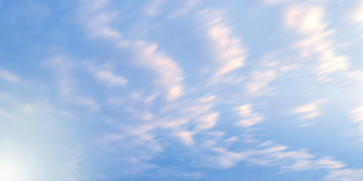 Motion blur effect on a clear blue sky filled with soft white clouds creating a dynamic streaked high-speed movement background