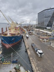 Obraz premium wharf of seaport trucks ships cargo operations.