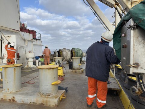 ship crew working on deck aft part of the ship.j