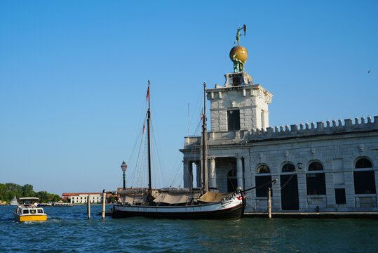 Venice, Italy, ancient customs building Punta Della Dogana with sail boat and water bus
