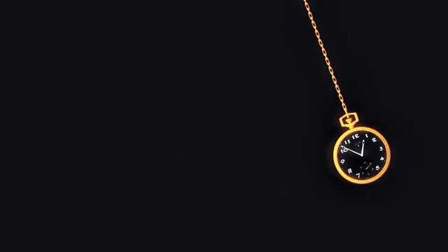 Gold pocket watch hanging on a chain against a dark black background symbolizing time concept