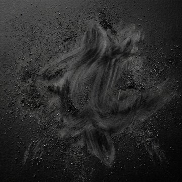 Fine graphite powder texture on a dark matte surface 
