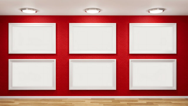 Six empty picture frames arranged on a red gallery wall with ceiling lights