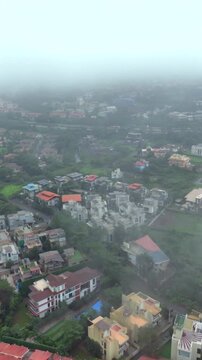 Vertical Aerial View of Lonavala Waterfall and Misty Green Hills During Monsoon Maharashtra