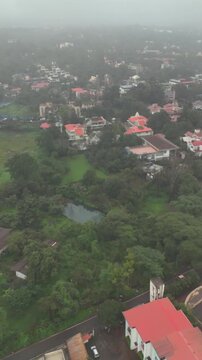 Vertical Aerial View of Lonavala Waterfall and Misty Green Hills During Monsoon Maharashtra