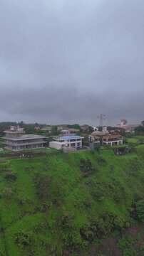 Vertical Aerial View of Lonavala Waterfall and Misty Green Hills During Monsoon Maharashtra