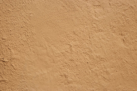Soil wall texture of clay house structure with sunlight . Mud background. selective focus