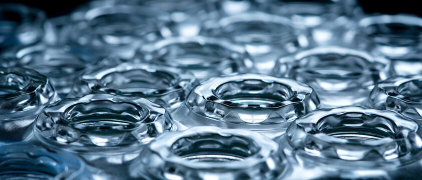 Rows of empty transparent glass bottles in closeup