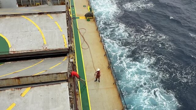 eam of seafarers washing ship at sea.