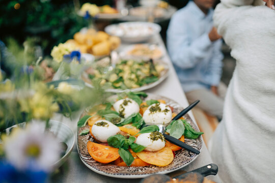 Delicious caprese salad on dining table at backyard family lunch