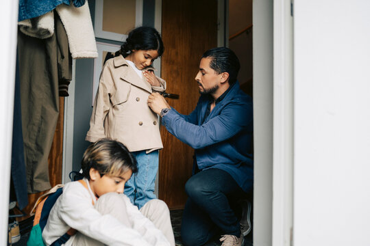 Father and children getting ready before leaving house