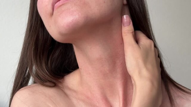 Young woman hands performing lymphatic drainage self massage on her neck side muscles. Beauty, health and anti-aging routine concept.