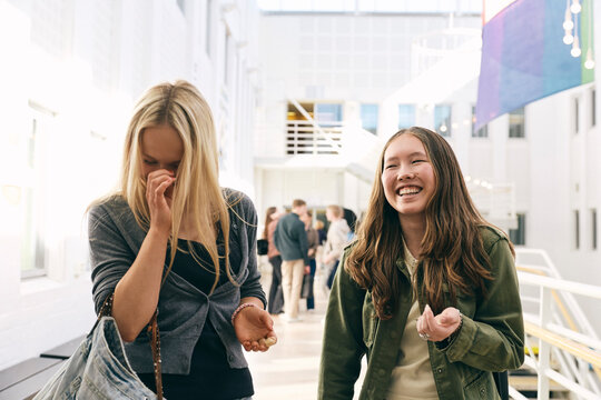 Multiracial female college students enjoying their leisure time with each other in lobby