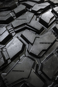 Black tire tread texture background with detailed rubber pattern.