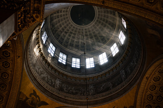 Ornate dome interior of Kazan Cathedral in Saint Petersburg with sunlit arched windows.