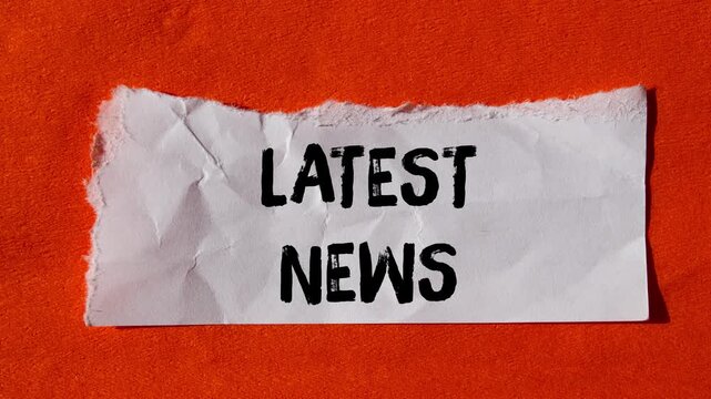 Latest news message writing on ripped torn paper background