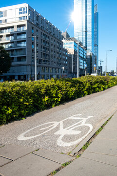 Urban bicycle path beside modern buildings in Warsaw Poland connects cycling infrastructure architecture and greenery along a clear mobility route through the city