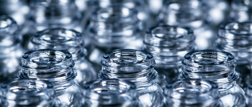 Rows of empty transparent glass bottles in closeup