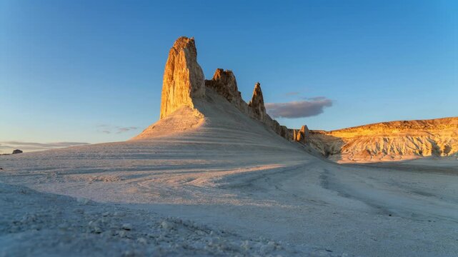 Altau sunrise timelapse video frame showing an suv parked near massive limestone formations in Kazakhstan during daytime outdoor environment with no people
