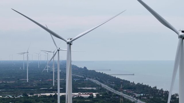 An aerial view of wind turbines for electricity generation captured by a drone camera.