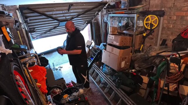 Time lapse man cleaning messy accumulation of household clutter organizing garage stuff