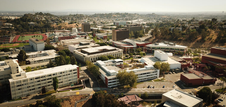 Aerial view of California State University, Los Angeles campus featuring modern academic buildings, athletic fields, and surrounding hills in Los Angeles, California, United States.