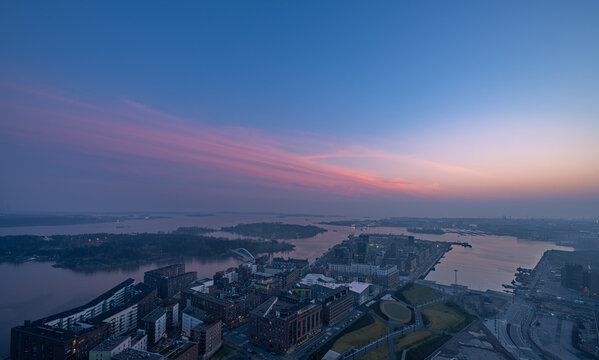 Aerial view of Kalasatama Towers overlooking the Helsinki skyline at dusk with pink clouds over the Baltic Sea in Helsinki, Uusimaa, Finland.