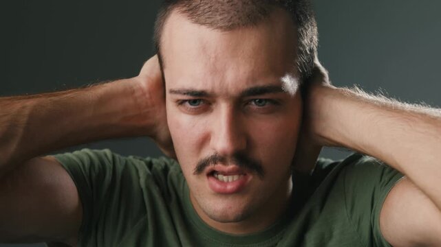 Distressed Young Man Covering His Ears In Psychological Crisis