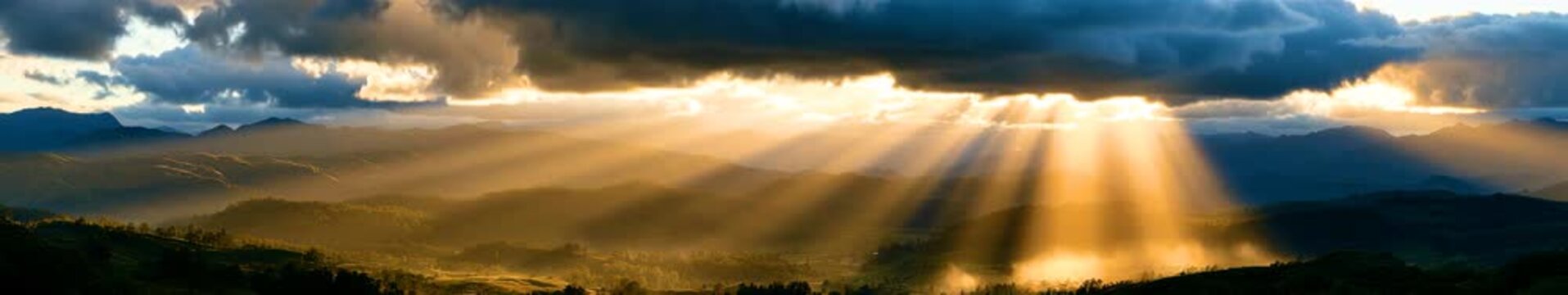 Dramatic Sunbeams Over Mountain Valley in a Widescreen Seamless Loop Animation with Storm Clouds and Golden Light