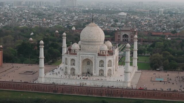 Aerial view of the taj mahal in agra, india, showcasing its mughal architecture, garden, and the surrounding cityscape