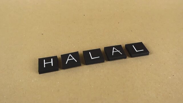 Black letter tiles spelling out the word halal, representing Islamic dietary law and permitted food certification, gliding over a light brown background with a subtle parallax effect