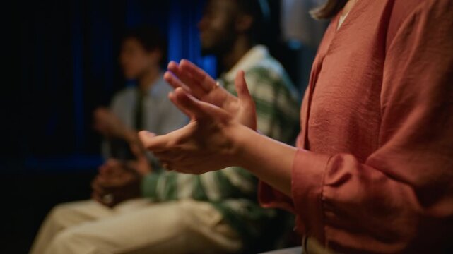 Multiethnic students clapping hands and applauding during live theater performance. Footage suitable for university campaigns, arts education promos, and event marketing